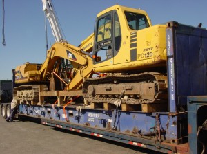 2 backhoes loaded onto a flat rack