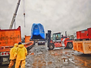 fork lift lifting large piece of machinery