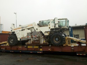 over dimensional machine loaded on a flat rack