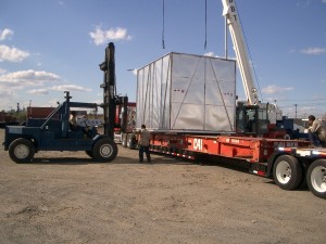 crane lifting large silver crate
