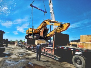 large backhoe loaded onto flat rack