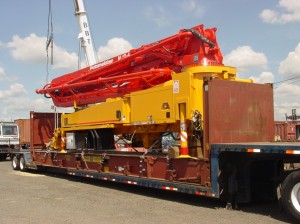 Concrete pump truck loaded on a flat rack